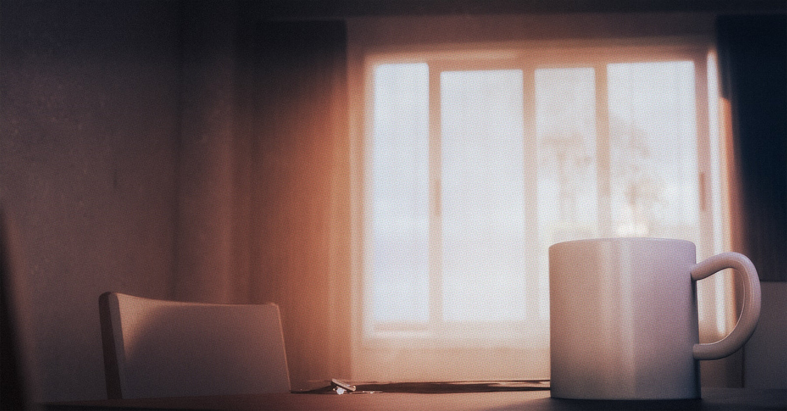 Steaming mug resting near a bright window