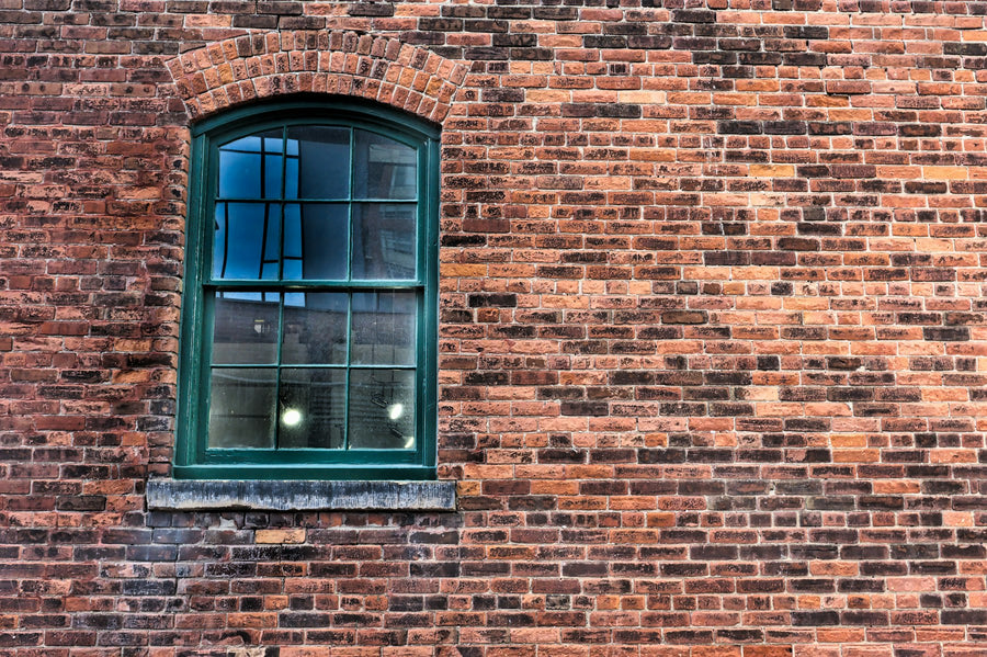 Small blue-framed window set in a brick wall