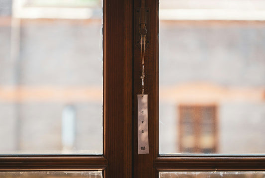 Close-up of a window with a metal pull tab on the sash