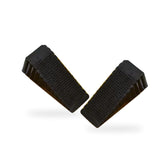 Two black ribbed rubber door stopper wedges on a white background