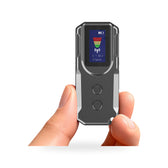 Hand holding a pocket-size hidden camera detector with a small display showing a signal bar graph