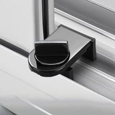 Black no-drill window and door lock clamped onto a white sliding track with its thumb-turn knob tightened
