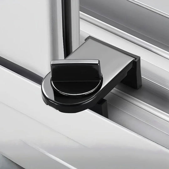 Black no-drill window and door lock clamped onto a white sliding track with its thumb-turn knob tightened