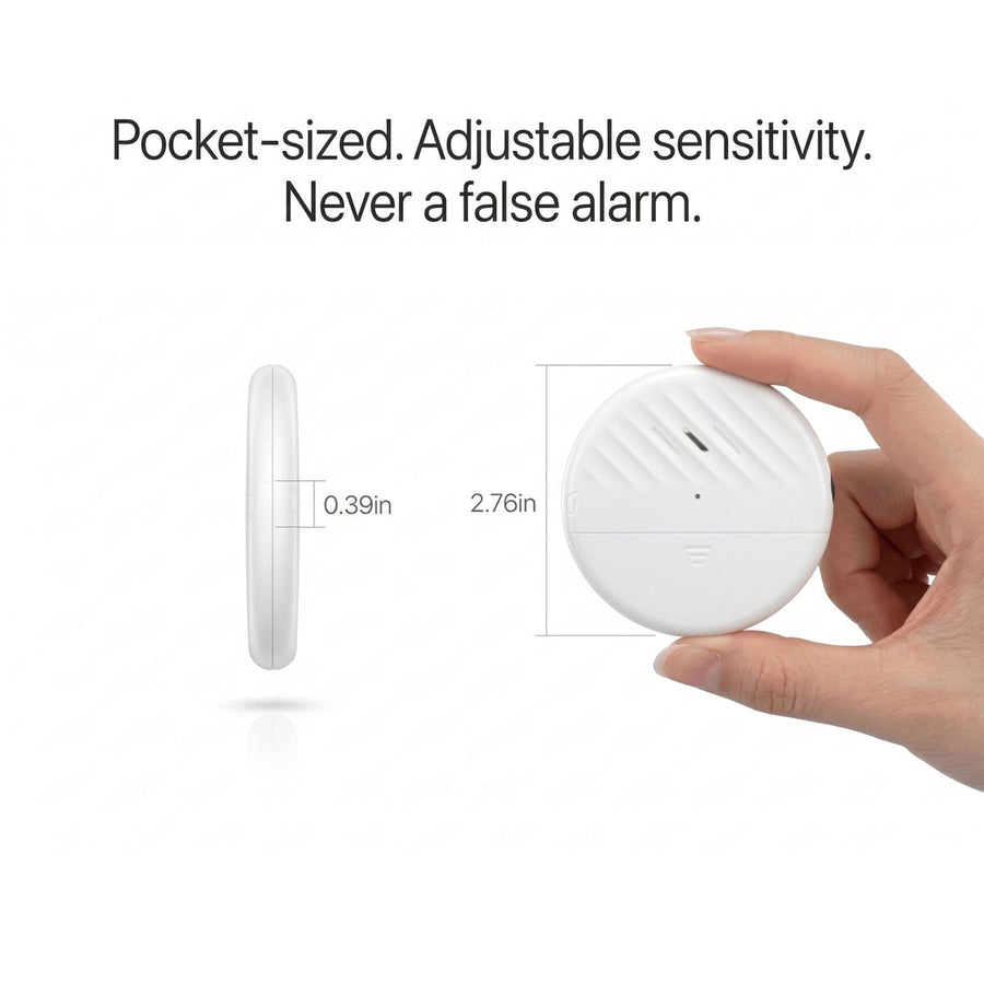The pocket-sized TremShield vibration alarm held in a hand